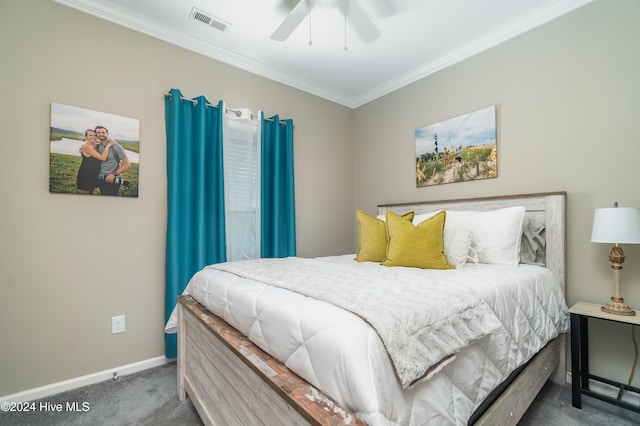 carpeted bedroom featuring ceiling fan and crown molding