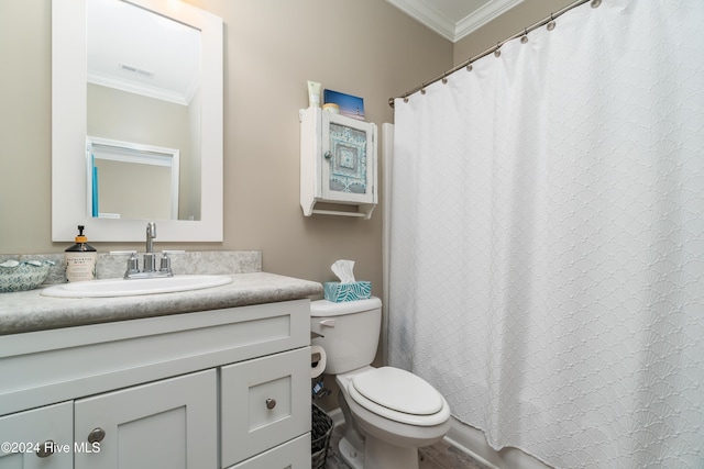 bathroom with vanity, toilet, and ornamental molding