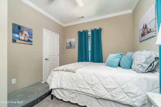 bedroom with carpet flooring, ceiling fan, and crown molding