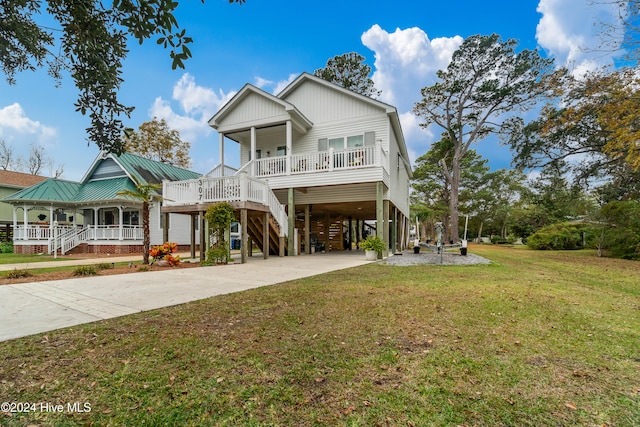 view of front of property featuring a carport, a porch, and a front yard