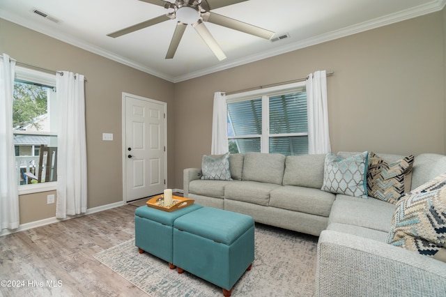 living room with light hardwood / wood-style flooring, ceiling fan, and crown molding