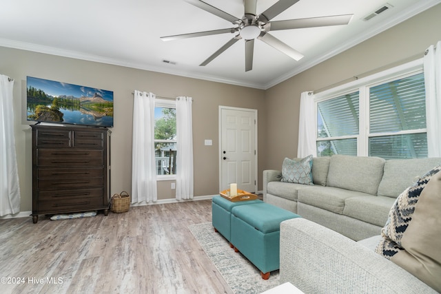 living room featuring light hardwood / wood-style flooring, ceiling fan, and crown molding