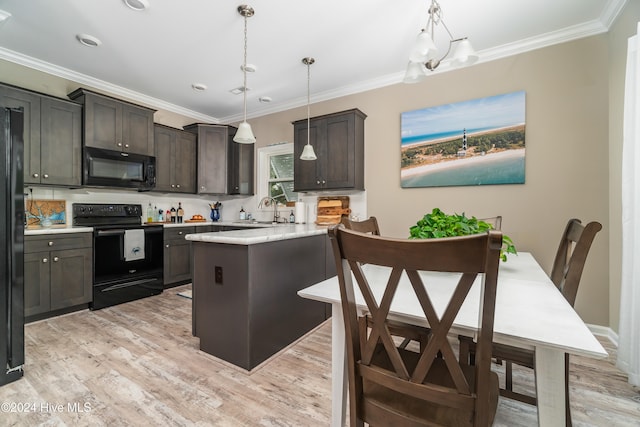 kitchen with pendant lighting, an inviting chandelier, black appliances, light hardwood / wood-style flooring, and dark brown cabinetry