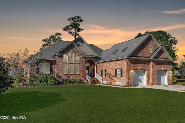 view of front of house featuring a garage and a lawn