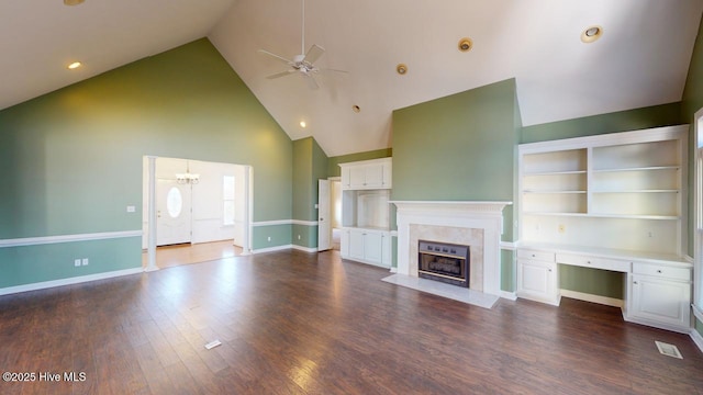 unfurnished living room with a high end fireplace, dark hardwood / wood-style floors, ceiling fan with notable chandelier, and high vaulted ceiling