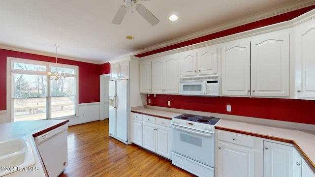 kitchen featuring ceiling fan with notable chandelier, white appliances, pendant lighting, light hardwood / wood-style flooring, and white cabinetry