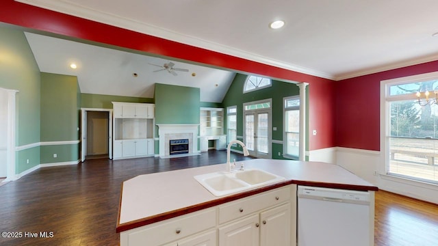 kitchen with a kitchen island with sink, white dishwasher, white cabinets, sink, and vaulted ceiling