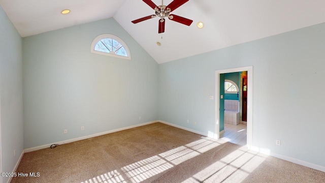 unfurnished room with ceiling fan, light carpet, and vaulted ceiling