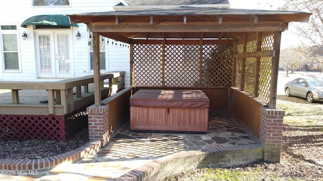 wooden terrace with a gazebo and a hot tub