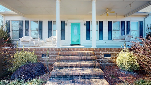 entrance to property featuring ceiling fan and covered porch