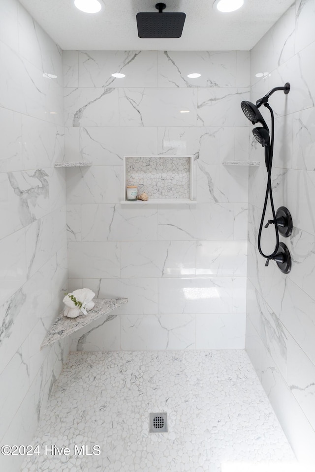 bathroom with a tile shower