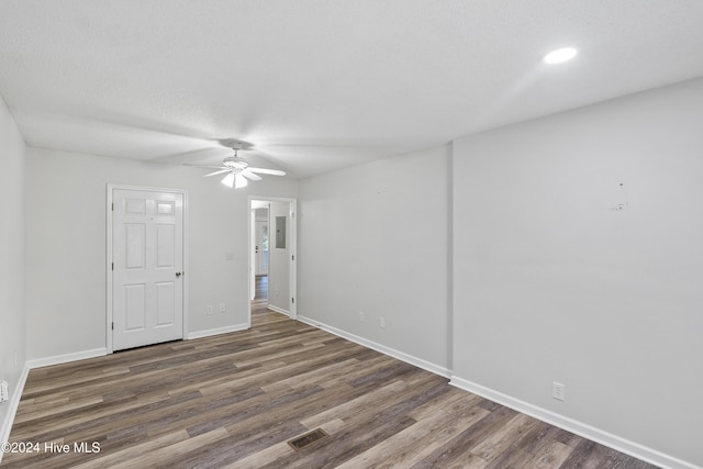 spare room featuring a ceiling fan, visible vents, recessed lighting, wood finished floors, and baseboards
