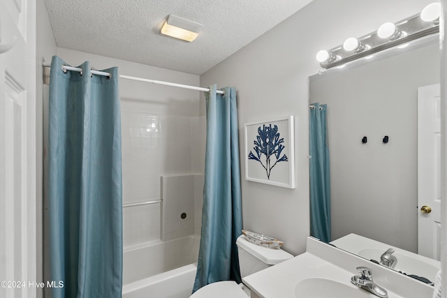 bathroom featuring shower / bath combination with curtain, a textured ceiling, vanity, and toilet
