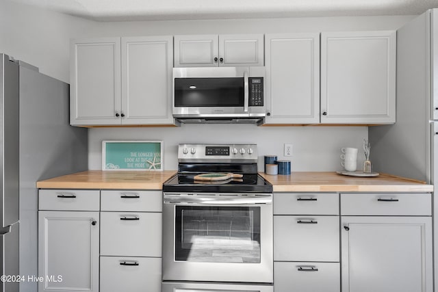 kitchen featuring white cabinets, a textured ceiling, and appliances with stainless steel finishes