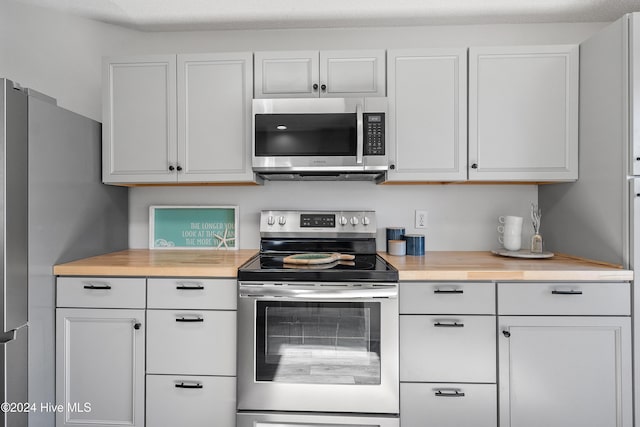 kitchen featuring appliances with stainless steel finishes, light countertops, and white cabinetry