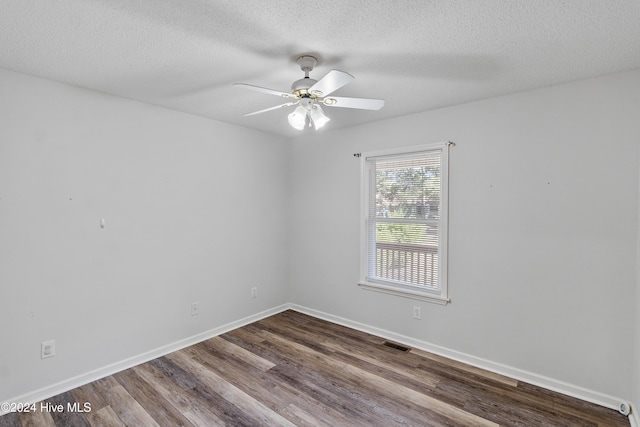 spare room with ceiling fan, a textured ceiling, and hardwood / wood-style flooring