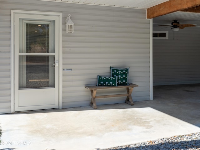 view of exterior entry with a patio and ceiling fan