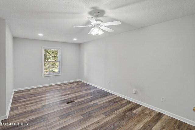 unfurnished room featuring baseboards, recessed lighting, visible vents, ceiling fan, and wood finished floors