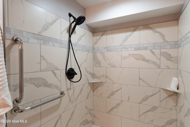 bathroom with tiled shower