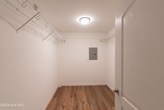 spacious closet with light wood finished floors and electric panel