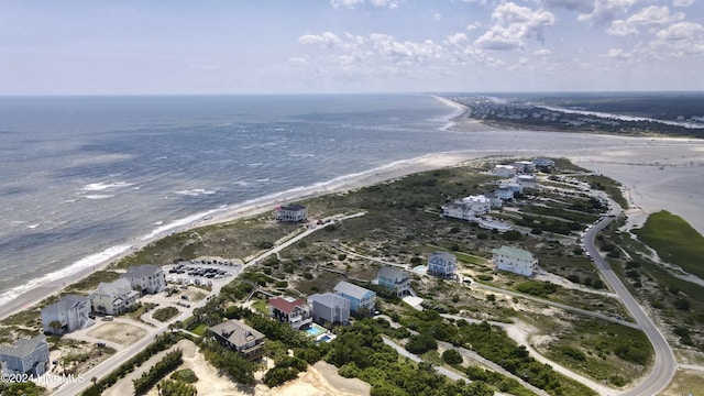 drone / aerial view with a water view and a beach view