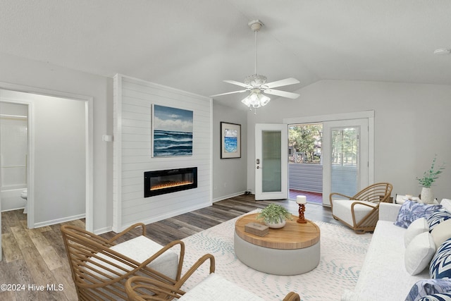 living room featuring a fireplace, hardwood / wood-style flooring, ceiling fan, and lofted ceiling