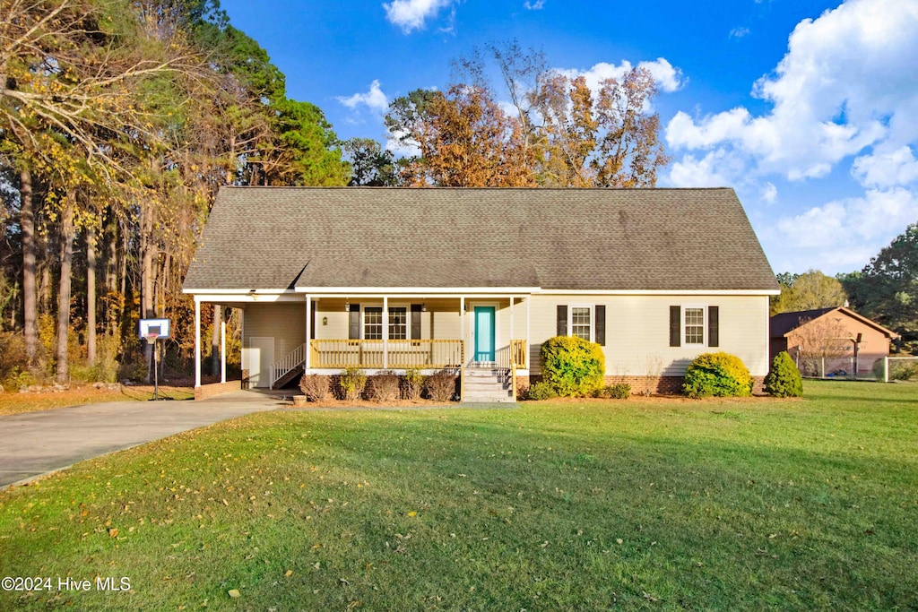 view of front of property with covered porch and a front yard