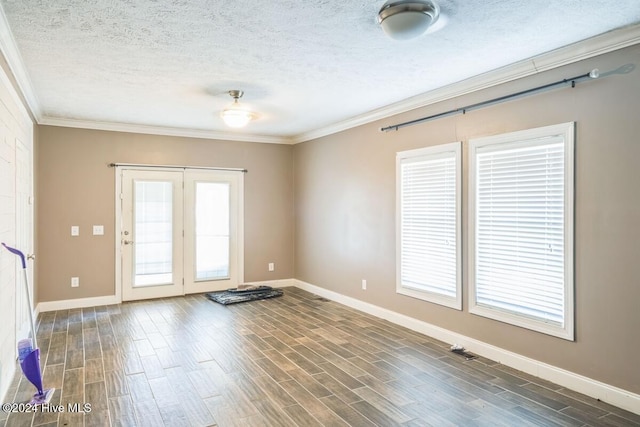 spare room featuring crown molding, dark hardwood / wood-style flooring, and a textured ceiling