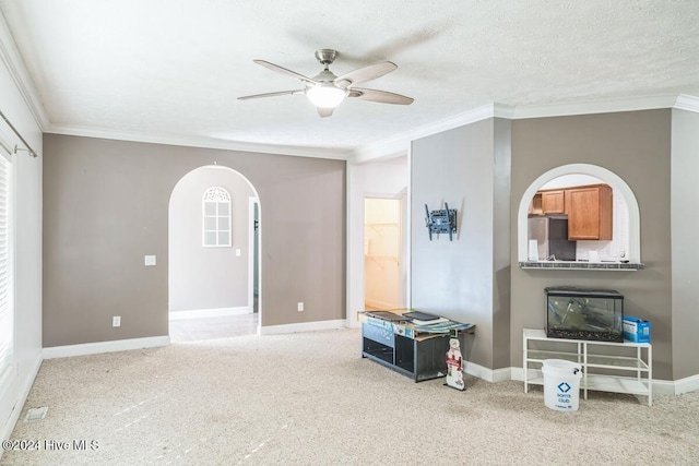 living room with crown molding, carpet floors, a textured ceiling, and ceiling fan