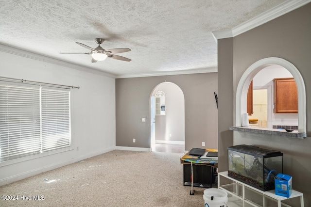 living room with ceiling fan, carpet, a textured ceiling, and ornamental molding