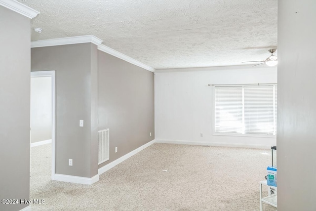 carpeted spare room featuring a textured ceiling, ceiling fan, and ornamental molding