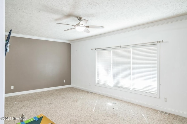 carpeted empty room featuring a textured ceiling, ceiling fan, and crown molding