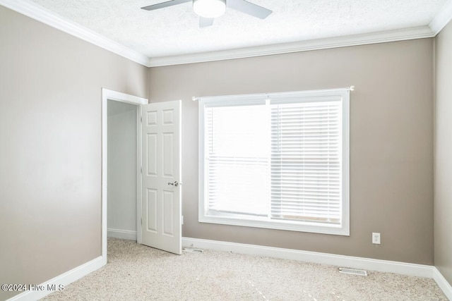 spare room with a textured ceiling, ceiling fan, and ornamental molding