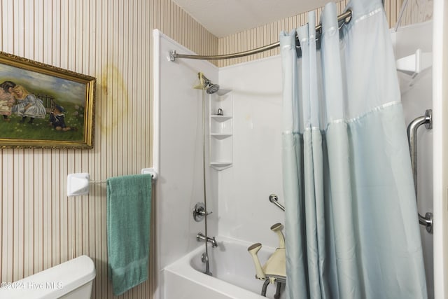 bathroom featuring toilet, a textured ceiling, and shower / tub combo with curtain