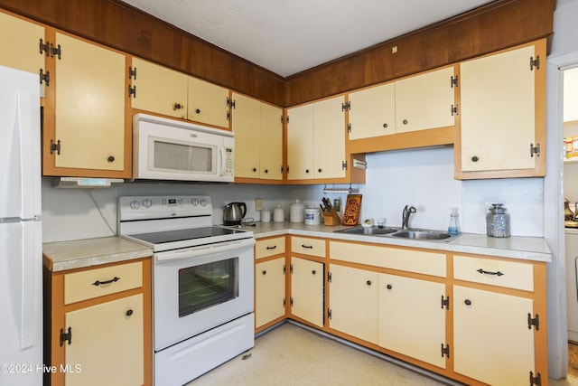 kitchen featuring white appliances and sink