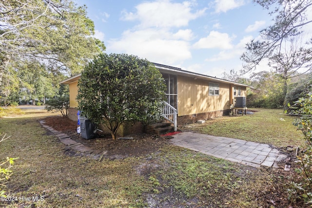 exterior space featuring a lawn and central AC