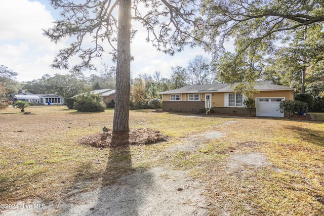 ranch-style home with a front yard and a garage