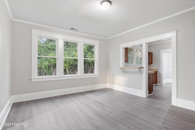 unfurnished room with ornamental molding and dark wood-type flooring