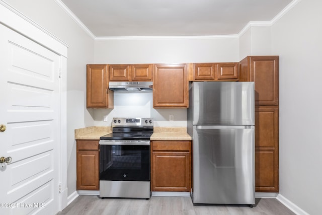 kitchen featuring stainless steel appliances, light hardwood / wood-style flooring, and ornamental molding