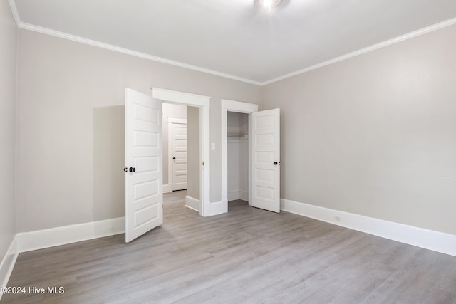 unfurnished bedroom with crown molding and light hardwood / wood-style floors