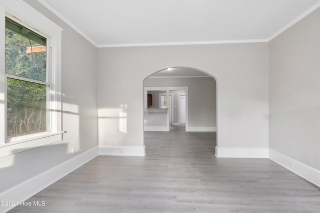 unfurnished room featuring light hardwood / wood-style floors and crown molding