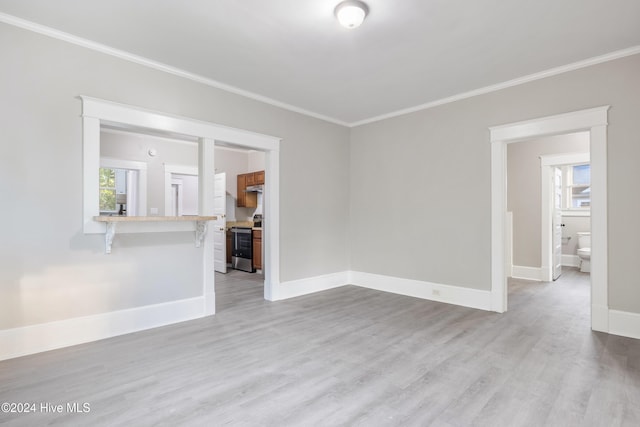 unfurnished living room featuring crown molding and light hardwood / wood-style flooring