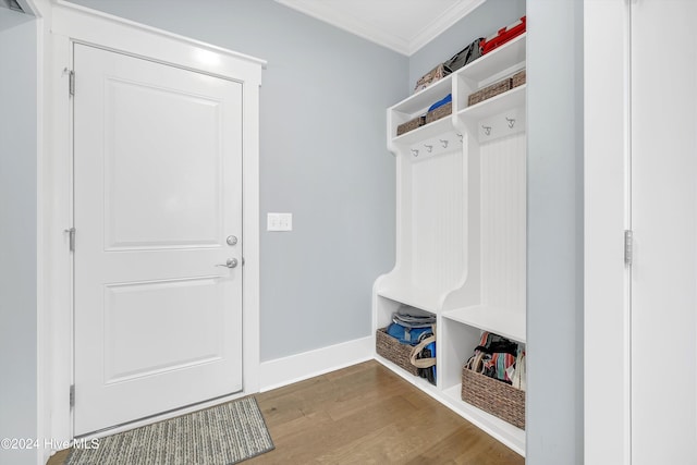 mudroom with wood-type flooring and ornamental molding