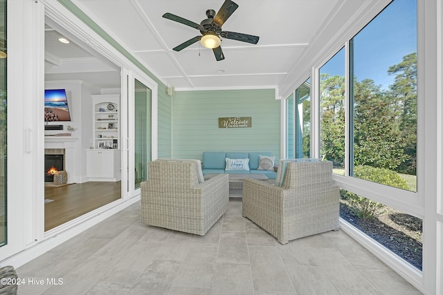 sunroom featuring ceiling fan