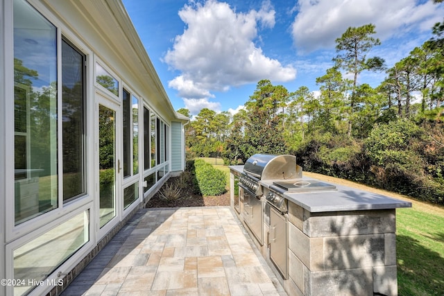 view of patio / terrace featuring a grill and exterior kitchen