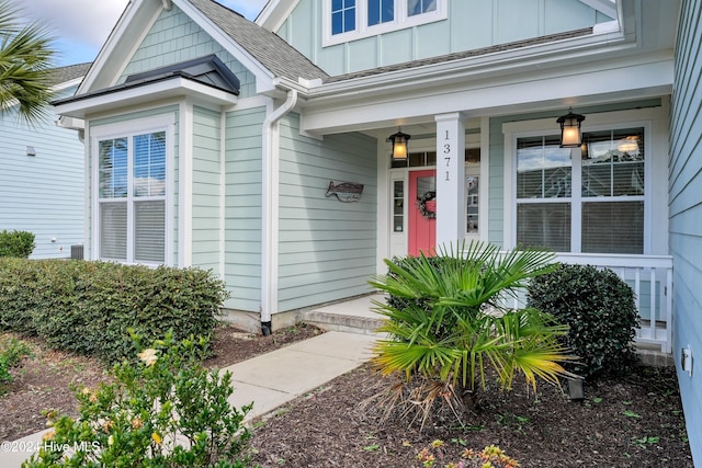 view of exterior entry with covered porch