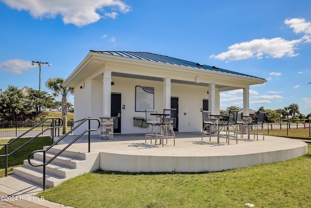 back of property featuring a patio area and a yard