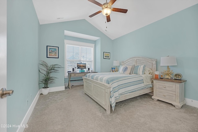 bedroom with light colored carpet, vaulted ceiling, and ceiling fan