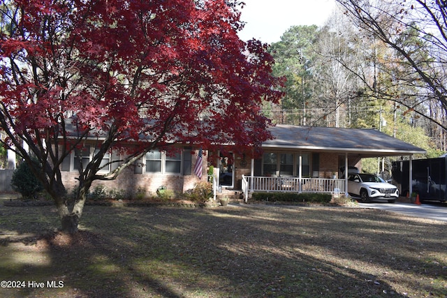 obstructed view of property with a carport and covered porch