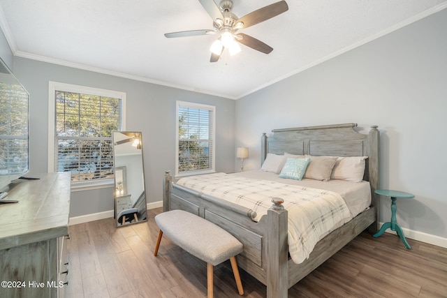 bedroom with hardwood / wood-style floors, ceiling fan, and ornamental molding